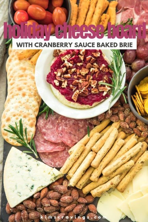 cheese board filled with meats, crackers, cheeses and cranberry