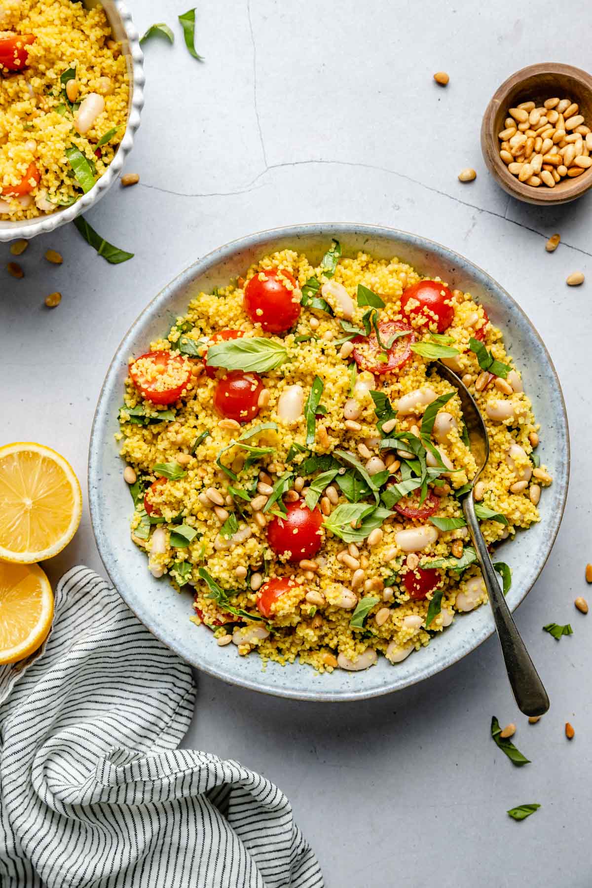 Salad made with couscous, cherry tomatoes, white beans and basil.