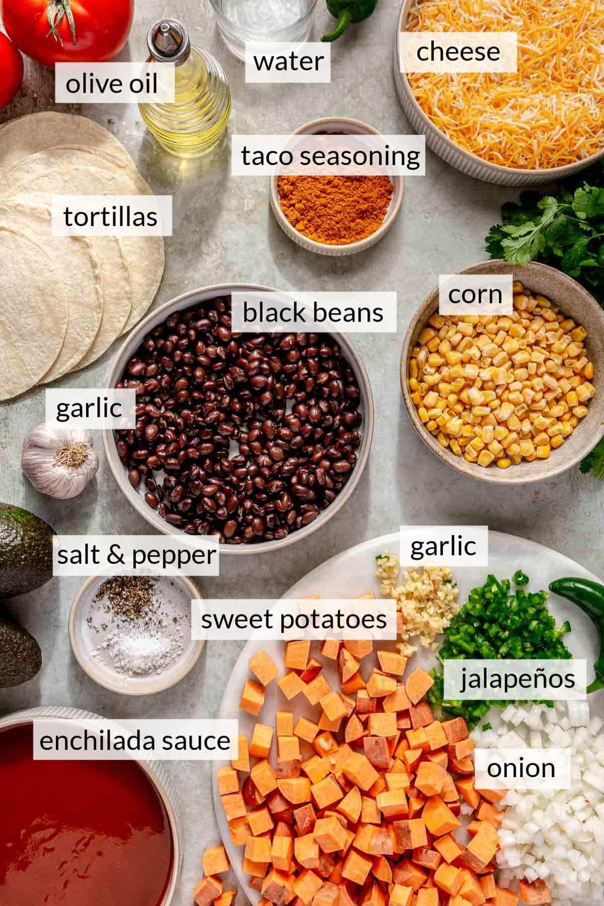 Bowls of black beans, corn, cheese and enchilada sauce near tortillas and cubed sweet potato.