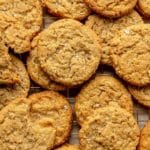 Peanut butter oatmeal cookies stacked on a parchment paper.