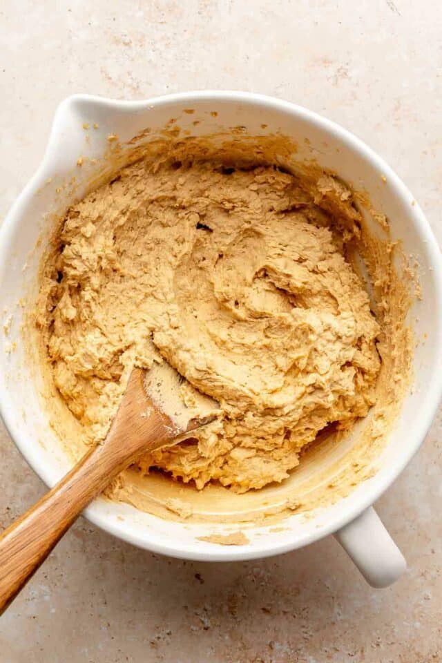 Peanut butter oatmeal cookie dough in a white mixing bowl.