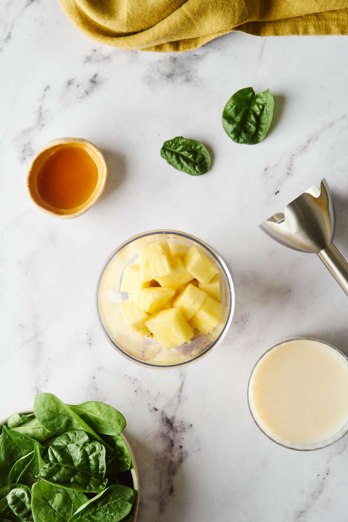 Pineapple chunks added to a blender.