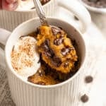 Spoonful of pumpkin mug cake with chocolate chips.