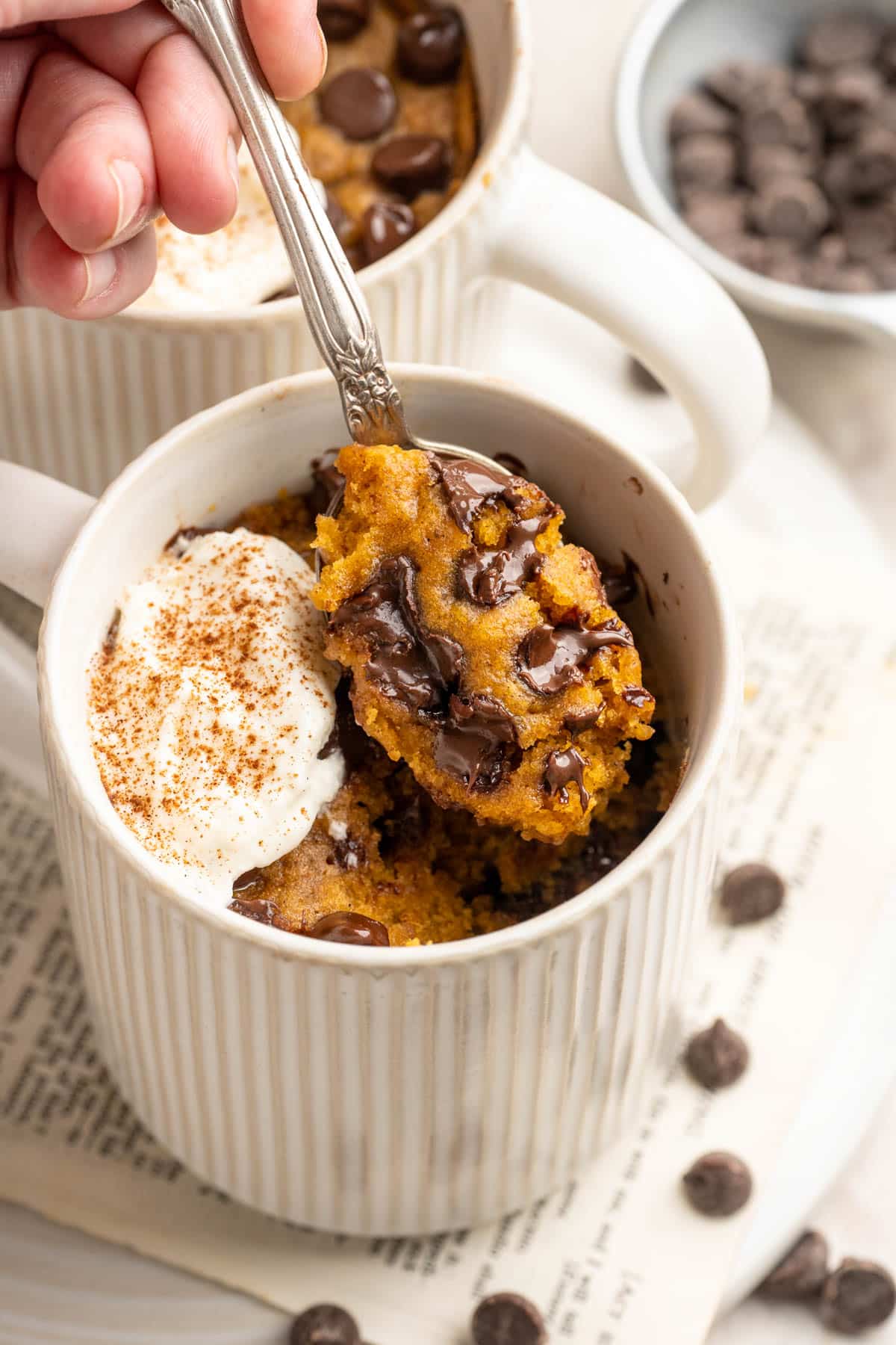 Spoonful of pumpkin mug cake with chocolate chips.