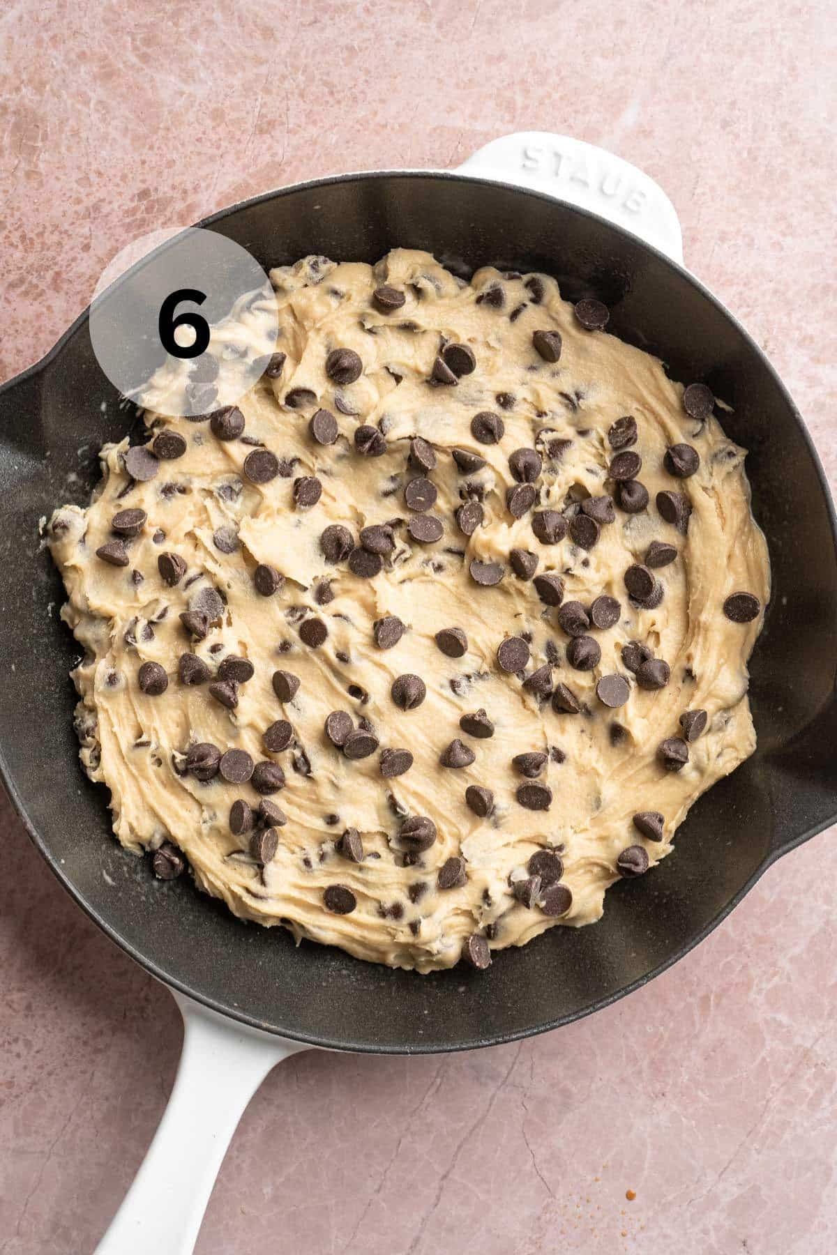 Cookie dough pressed into a skillet.