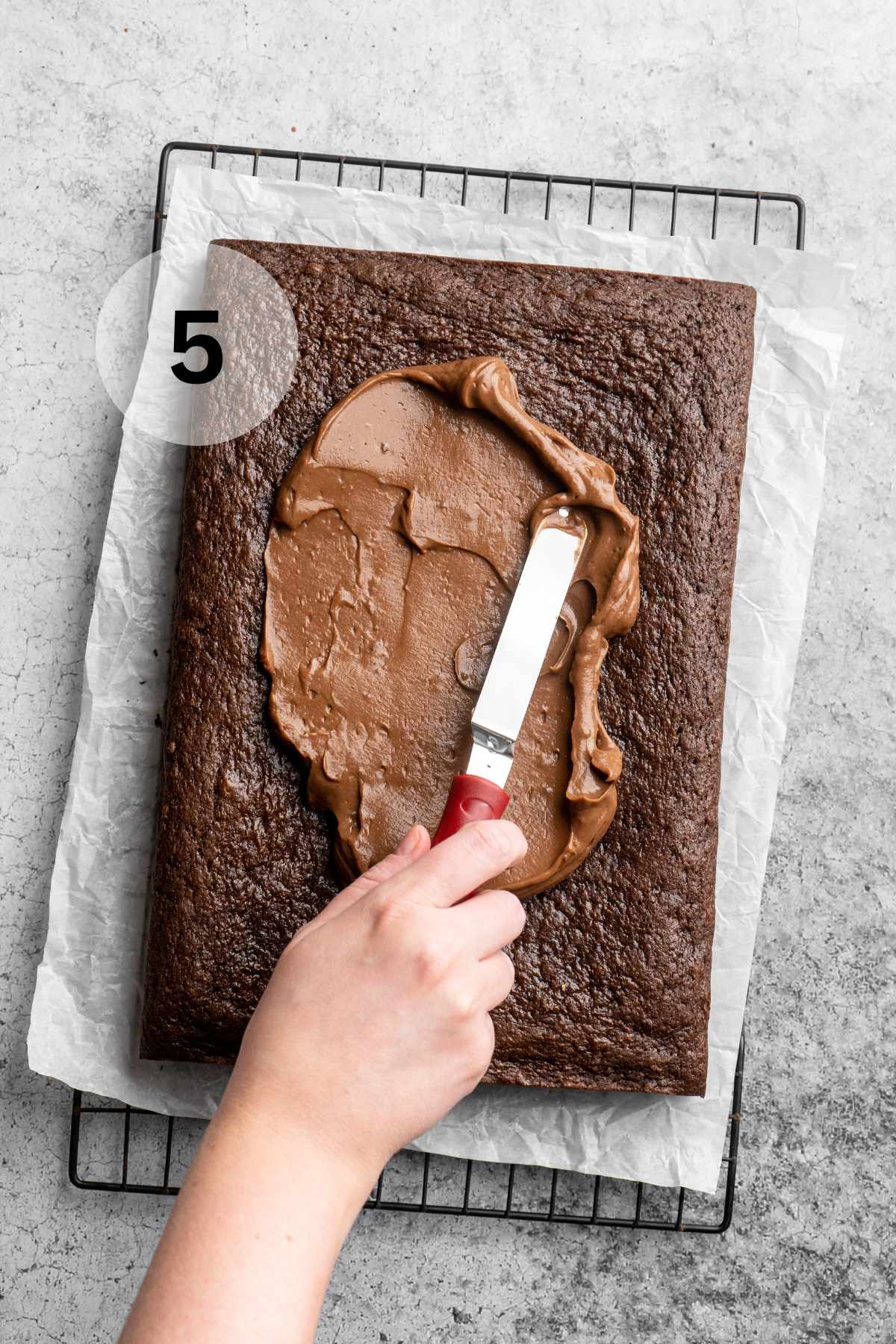 Spreading pudding over chocolate cake.