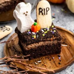 Graveyard Halloween dessert topped with a ghost peep, tombstone cookie and pumpkin candy.