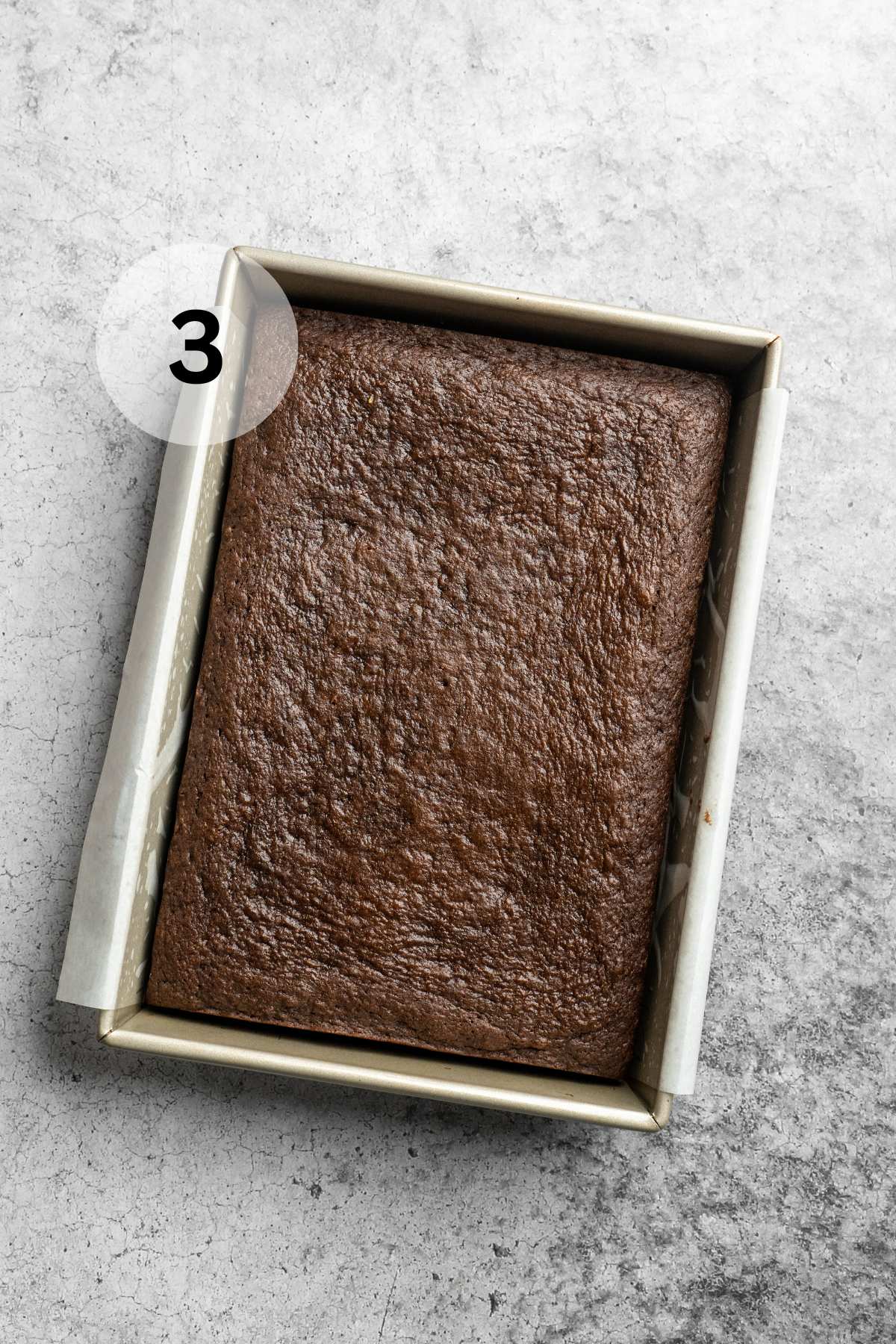 Baked chocolate cake in a 9x13-inch pan.