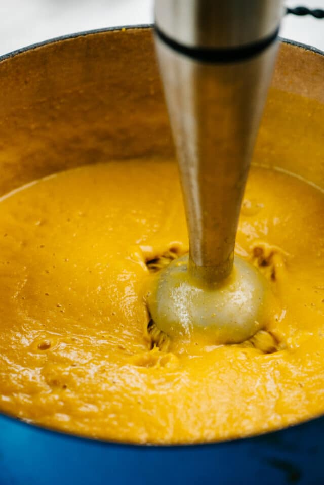 using an immersion blender to make butternut squash soup
