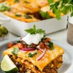 Mexican Lasagna topped with fresh cilantro, sour cream and Pico de Gallo.