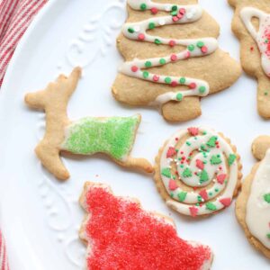 Sugar cookies cut into Christmas shapes and decorated with icing and sprinkles.
