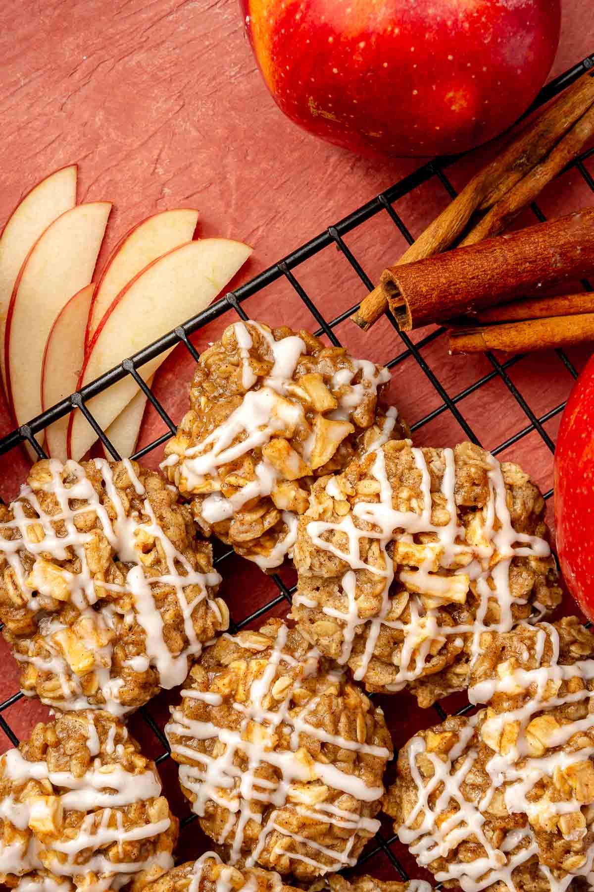 Iced apple cookies on a wire rack.
