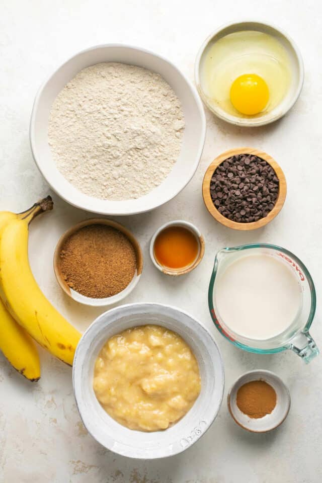 Ingredients for making banana muffins divided into small bowls.