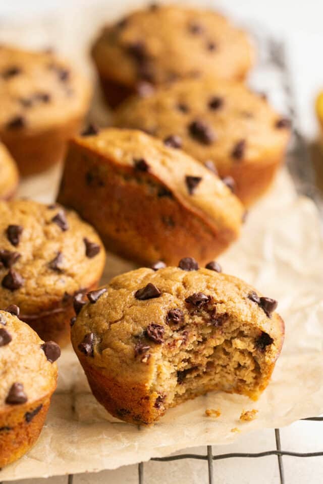 Chocolate chip muffin that has been bitten into.