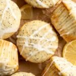 Lemon poppy seed muffins with glaze drizzled over the top.