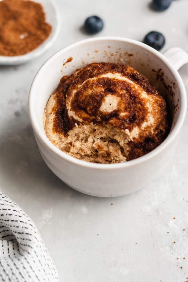 microwave mug cake recipe in a white mug with a bite taken out