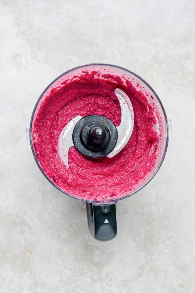 Beet hummus mixed in a food processor.