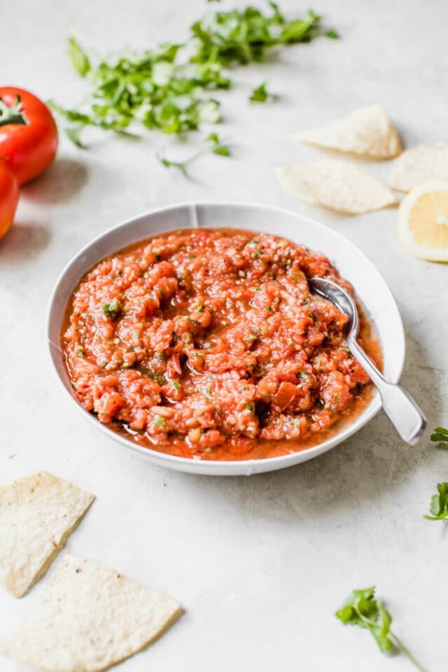salsa in a serving bowl with a silver spoon
