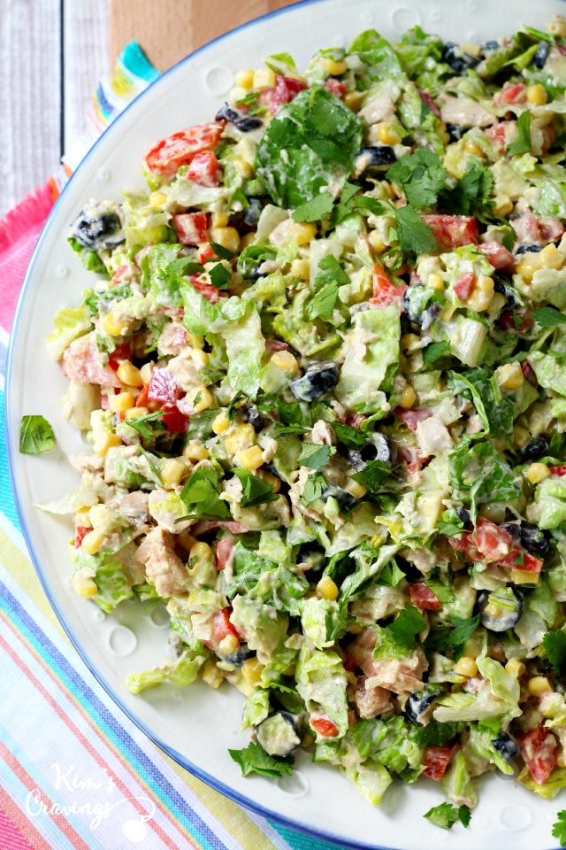 Mexican Chopped Tuna Salad- protein-packed tuna combined with chopped romaine, black beans, bell pepper, olives, sweet yellow corn, fresh tomatoes, avocado and a creamy taco-flavored dressing makes for the most incredibly tasty yumilicious tuna salads!