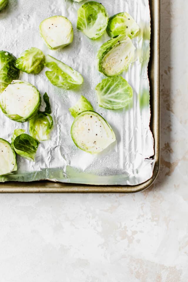 Raw Brussels sprouts on a large baking pan