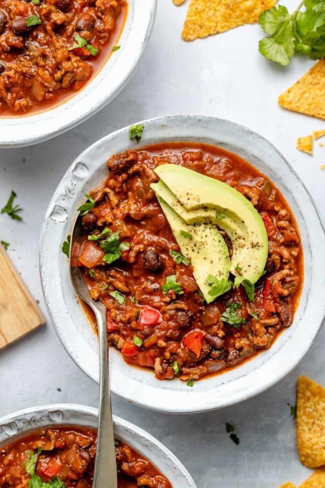 bison chili topped with avocado and fresh cilantro