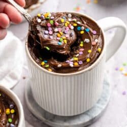 Getting a spoonful of frosted chocolate protein mug cake.