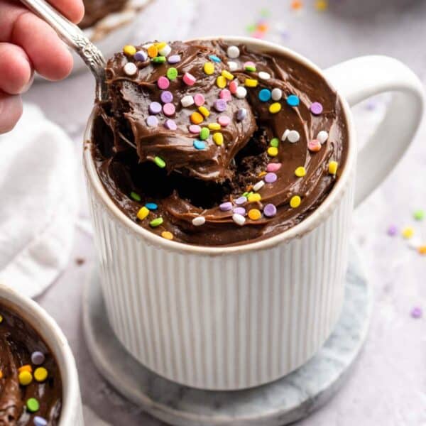 Getting a spoonful of frosted chocolate protein mug cake.