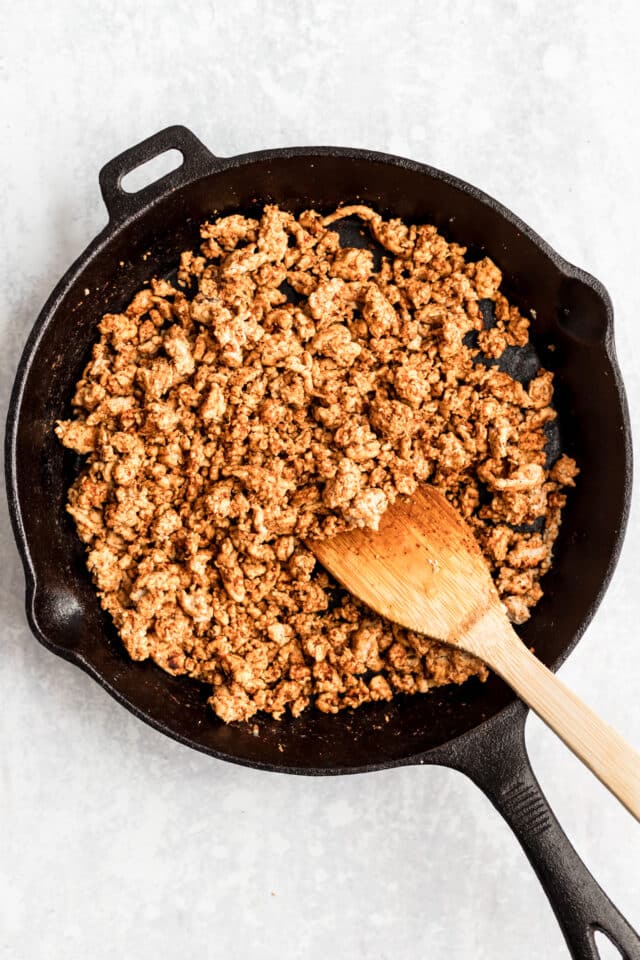 Healthy Taco Meat cooking in a large cast iron skillet