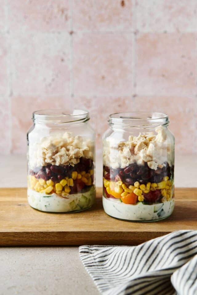 Chicken salad in a jar with black beans and dressing.