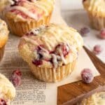 Cranberry orange muffins with a drizzle of glaze over the top.