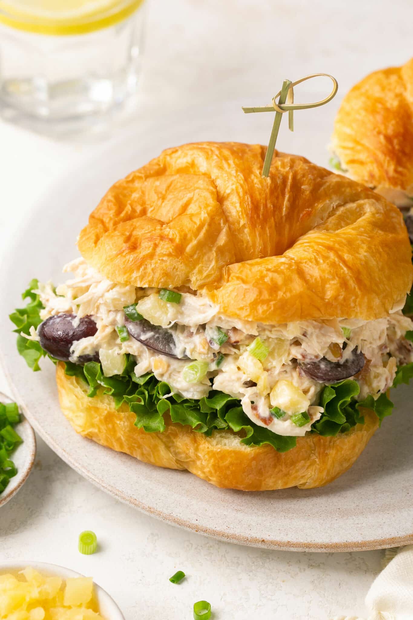 Chicken salad served on a croissant with lettuce.