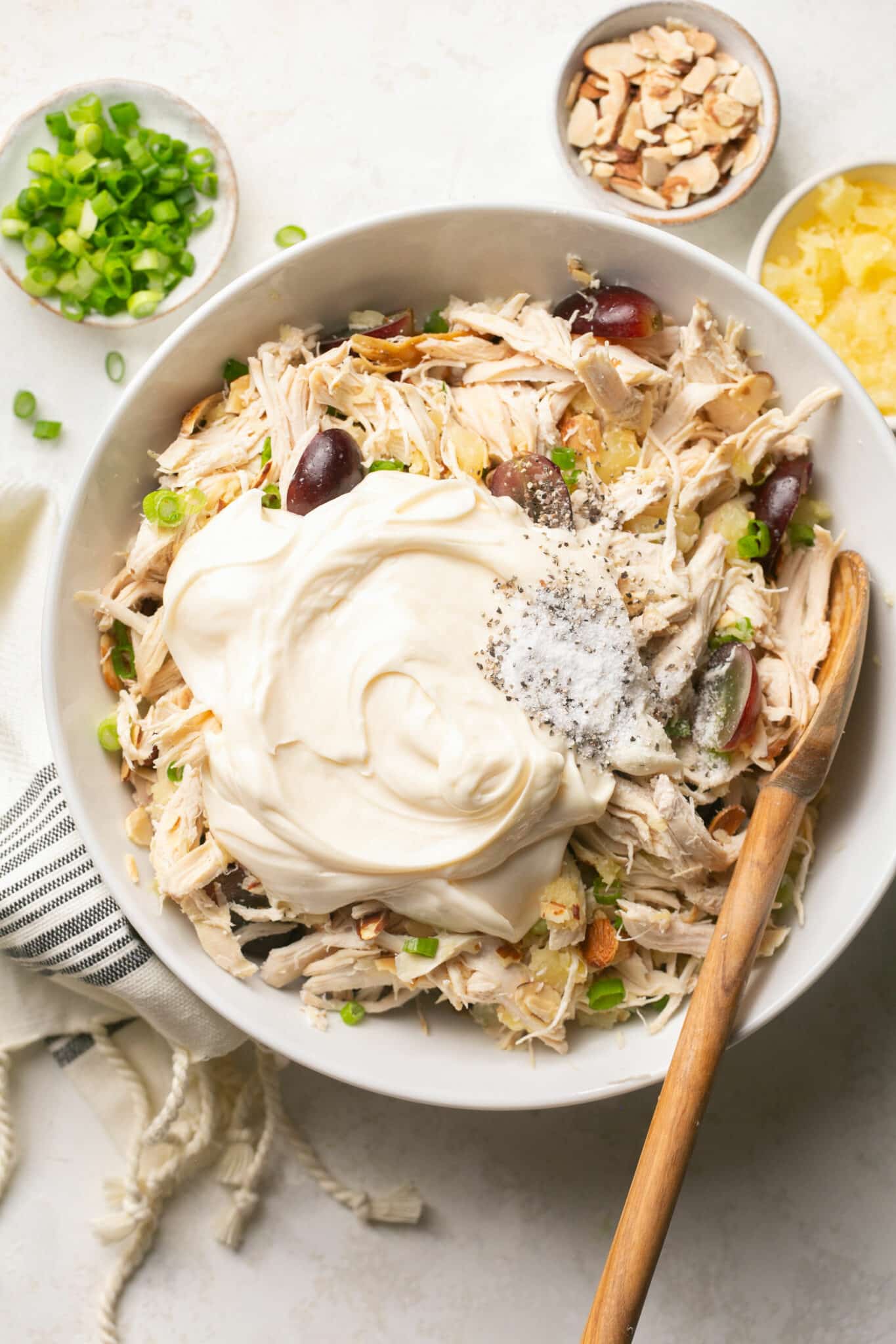Adding mayo to bowl with shredded chicken.