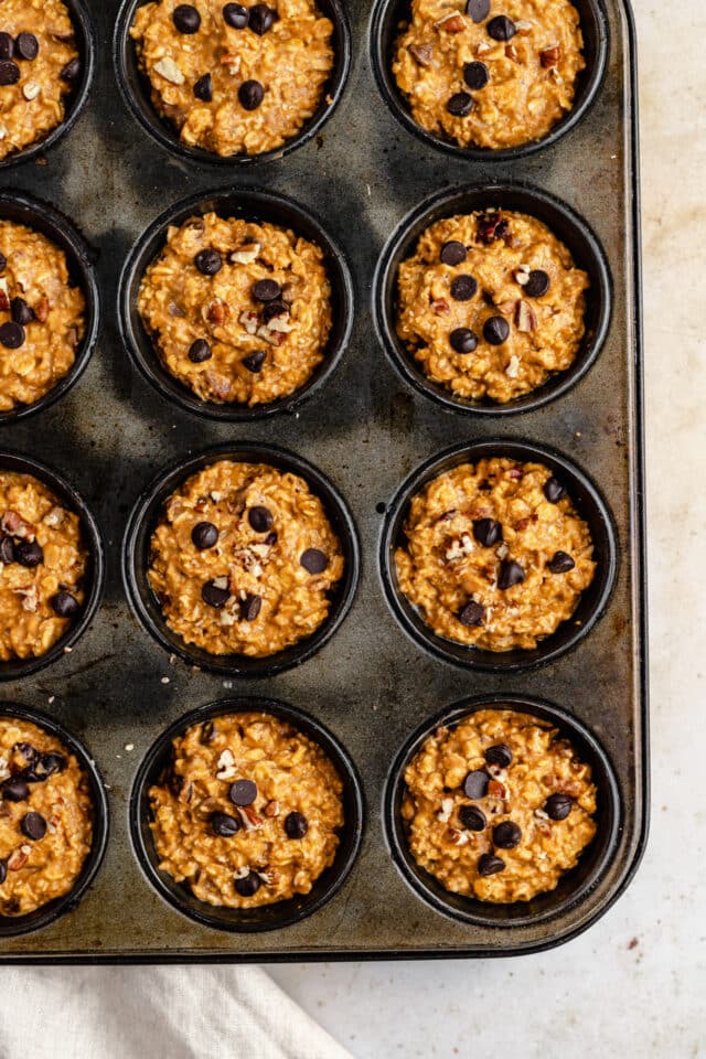 muffin pan filled with pumpkin oatmeal muffins