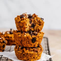 3 stacked pumpkin oatmeal muffins with chocolate chips