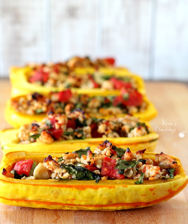 Roasted delicata squash brimming with lean turkey, nutritious spinach and juicy tomatoes makes for an incredibly delicious fall meal- this super simple stuffed delicata squash is a must try! (gluten-free & Paleo)