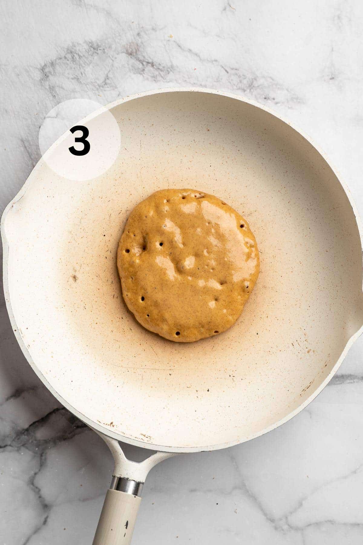 Cooking a pancake on a skillet.