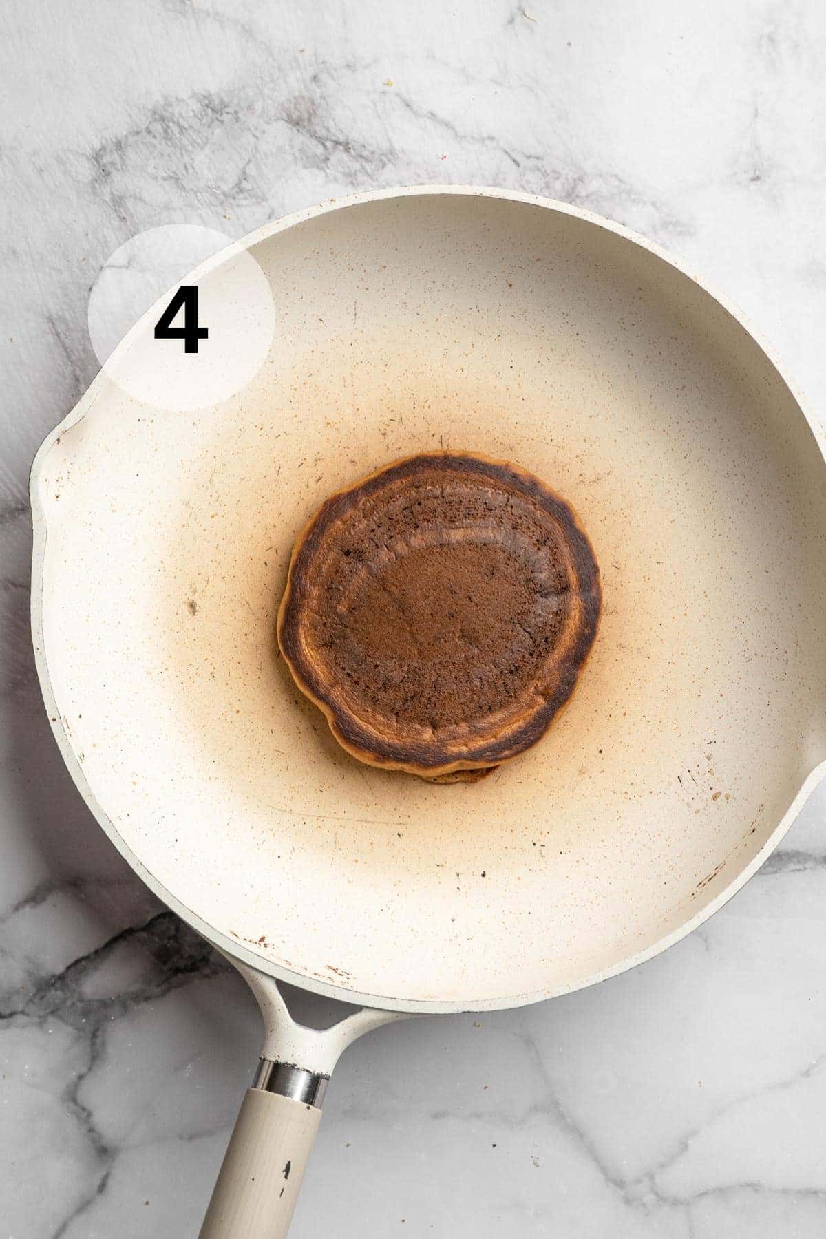 Cooked pancake on a large skillet.