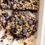 Blueberry baked oatmeal being served out of a baking dish.