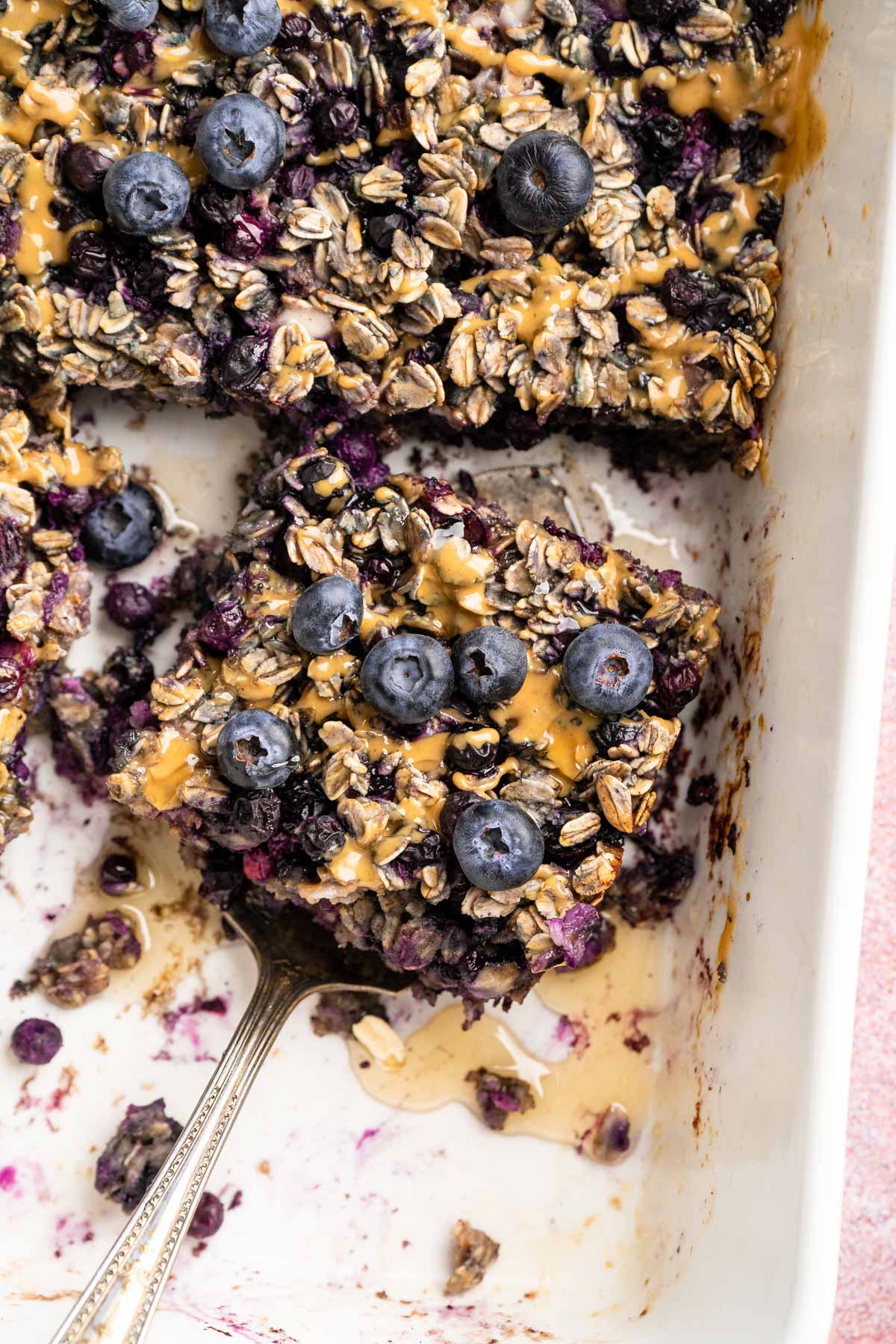 Blueberry baked oatmeal being served out of a baking dish.