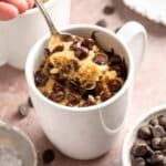 Spooning out a bite of cookie mug cake.