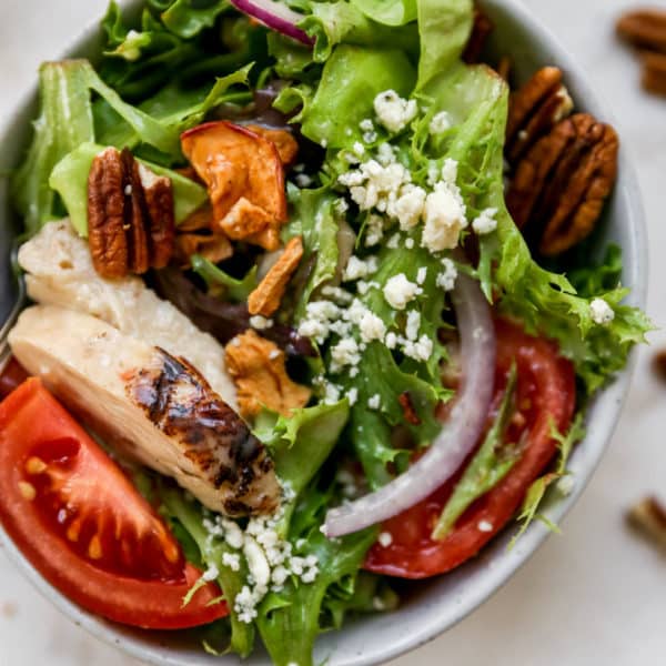 apple chicken salad with red onion, pecans, and tomato