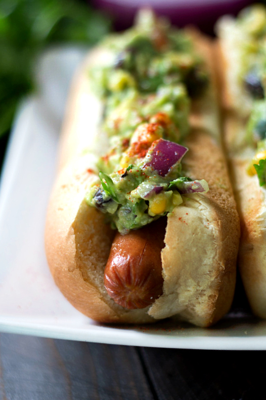Southwestern Guacamole Hot Dog- grilled Hebrew National Hot Dogs topped with flavorful Southwestern Guacamole. This one's a major crowd-pleaser!
