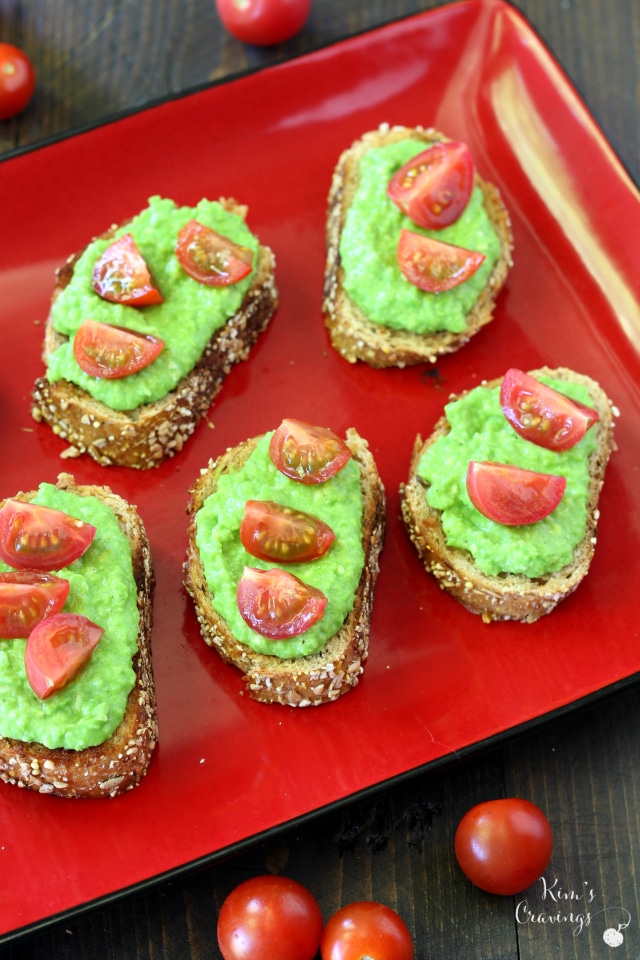 The joining of flavorful, light pea pesto spread over crusty bread and topped off with juicy cherry tomatoes makes this light pea pesto crostini appetizer a family favorite.