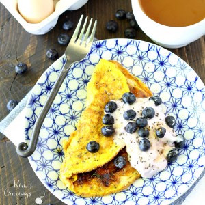 A light, maple flavored sweet omelet topped Greek yogurt and juicy blueberries is the perfect change of pace for breakfast!
