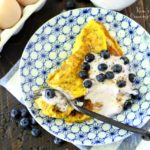 A light, maple flavored sweet omelet topped Greek yogurt and juicy blueberries is the perfect change of pace for breakfast!