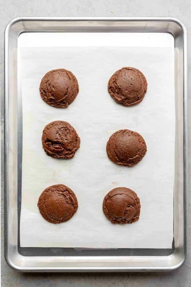 Brownie cookies on a parchment lined cookie sheet.