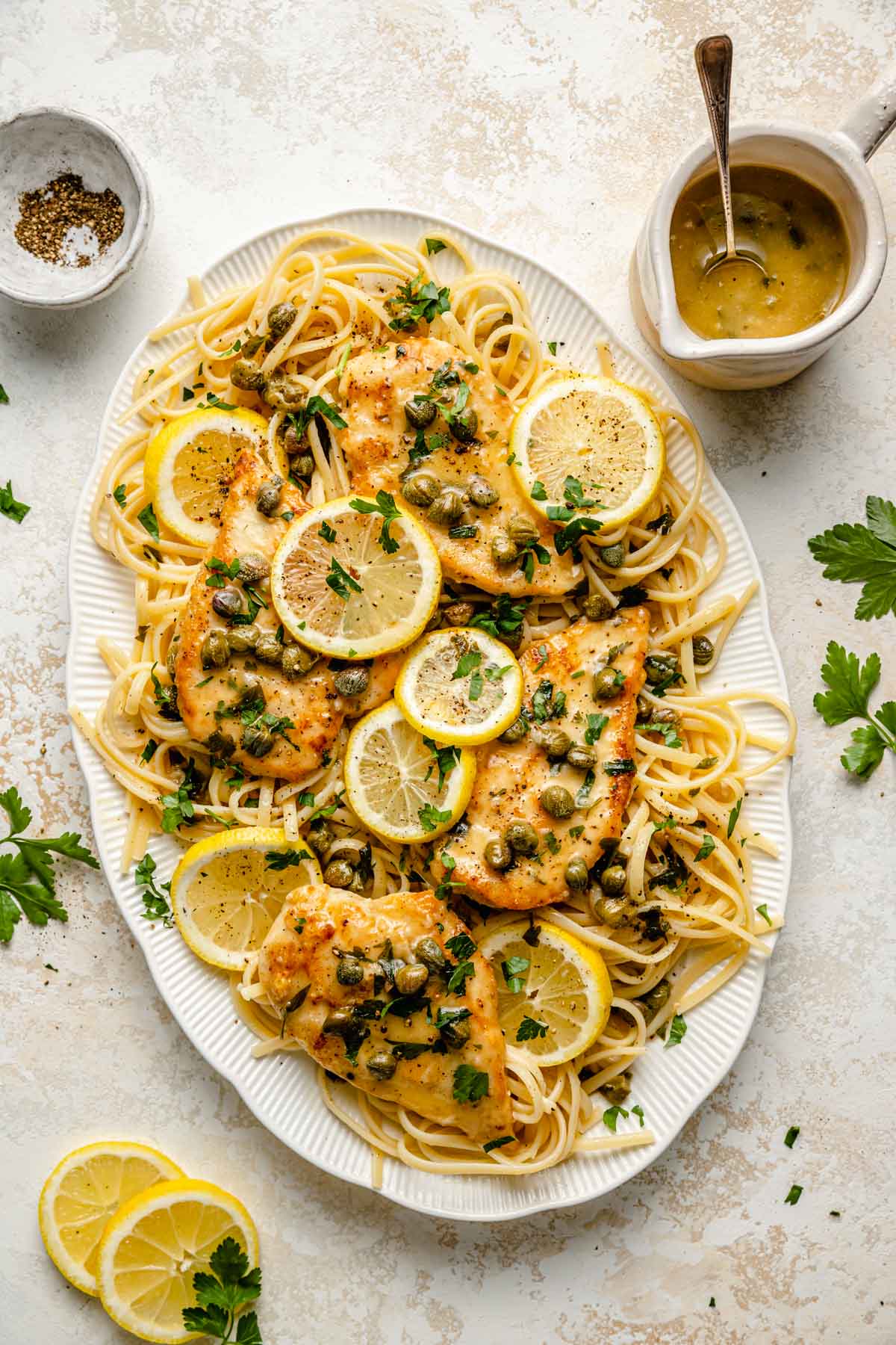 Chicken piccata served on white platter.