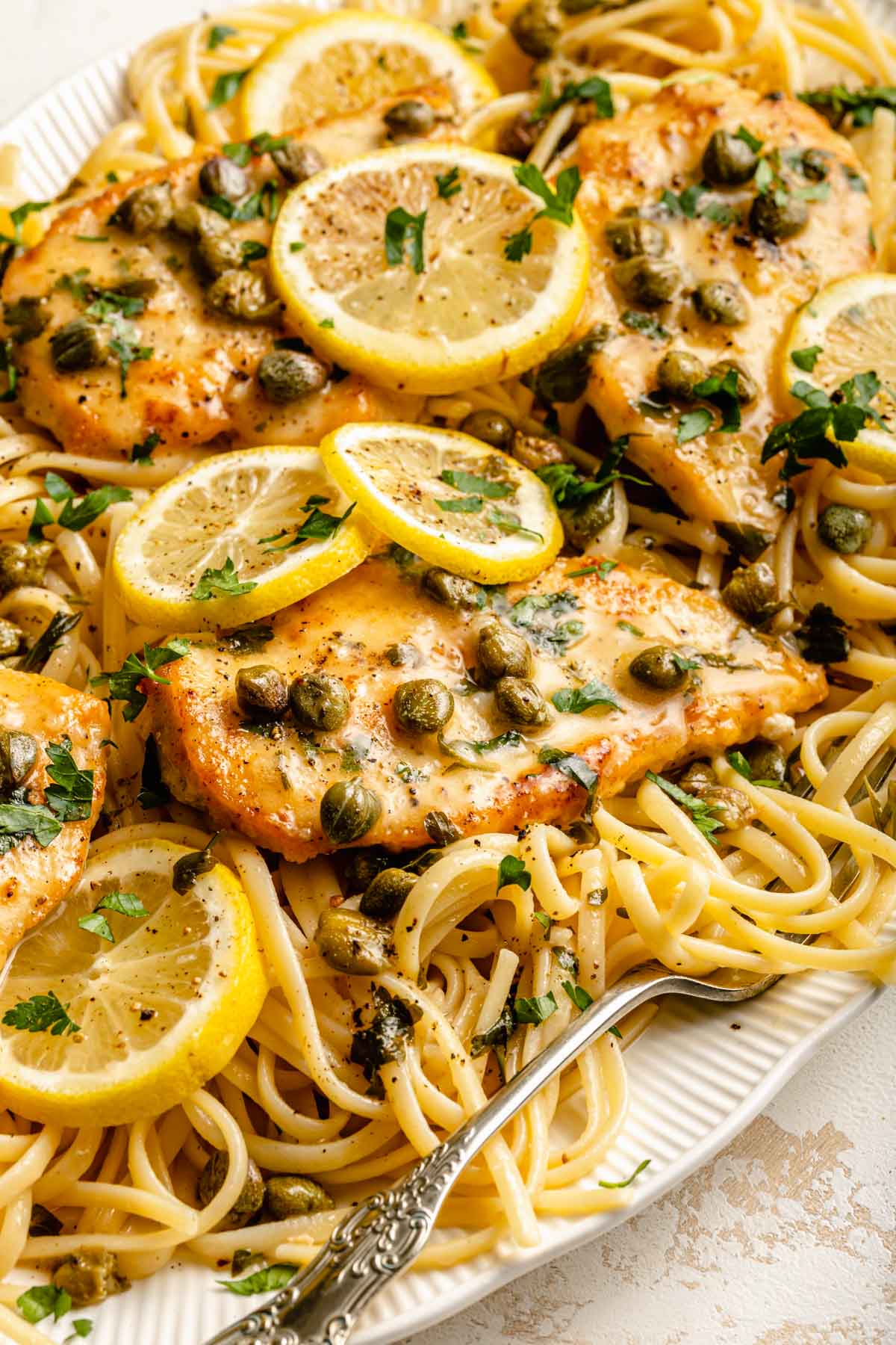 Chicken cutlets served over pasta.