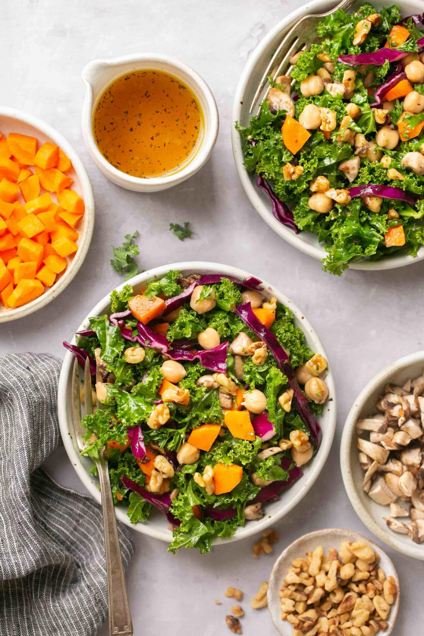 Two bowls filled with kale salad.
