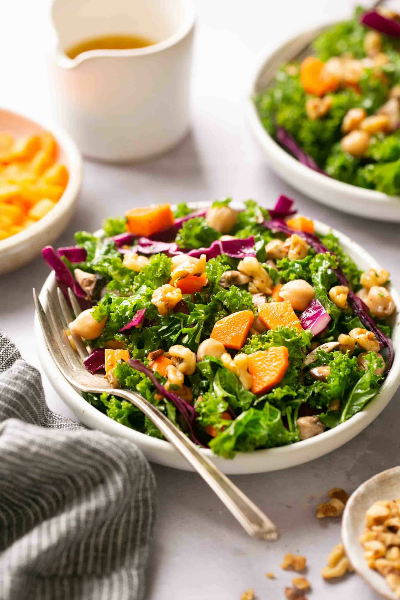 Fresh green salad topped with carrots.